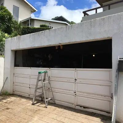 Old garage door partly removed during a door replacement